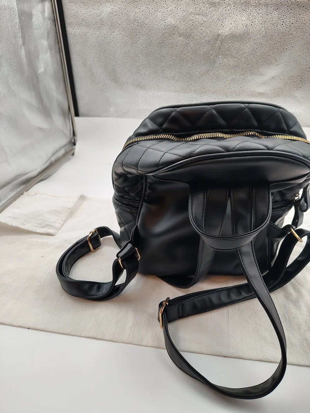 Quilted Black Mini Backpack with Gold Zip Accent